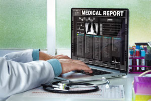 Doctor consulting a medical history on a computer / physician in consultation with a medical record of a patient on the screen of the laptop
